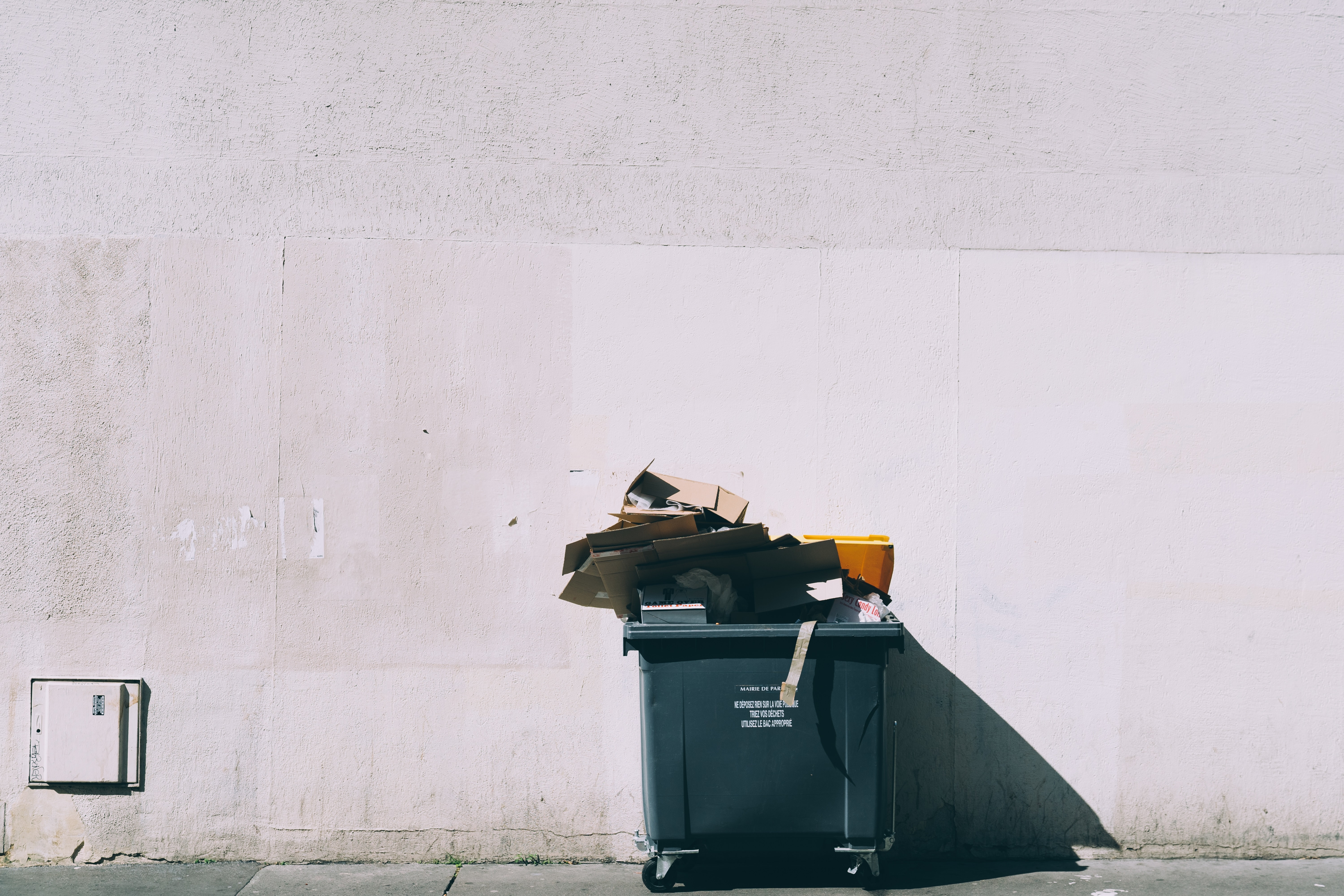 This image shows a dumpster with boxes and computers. We need to ensure we recycle and reuse our IT Systems securely to protect our data.