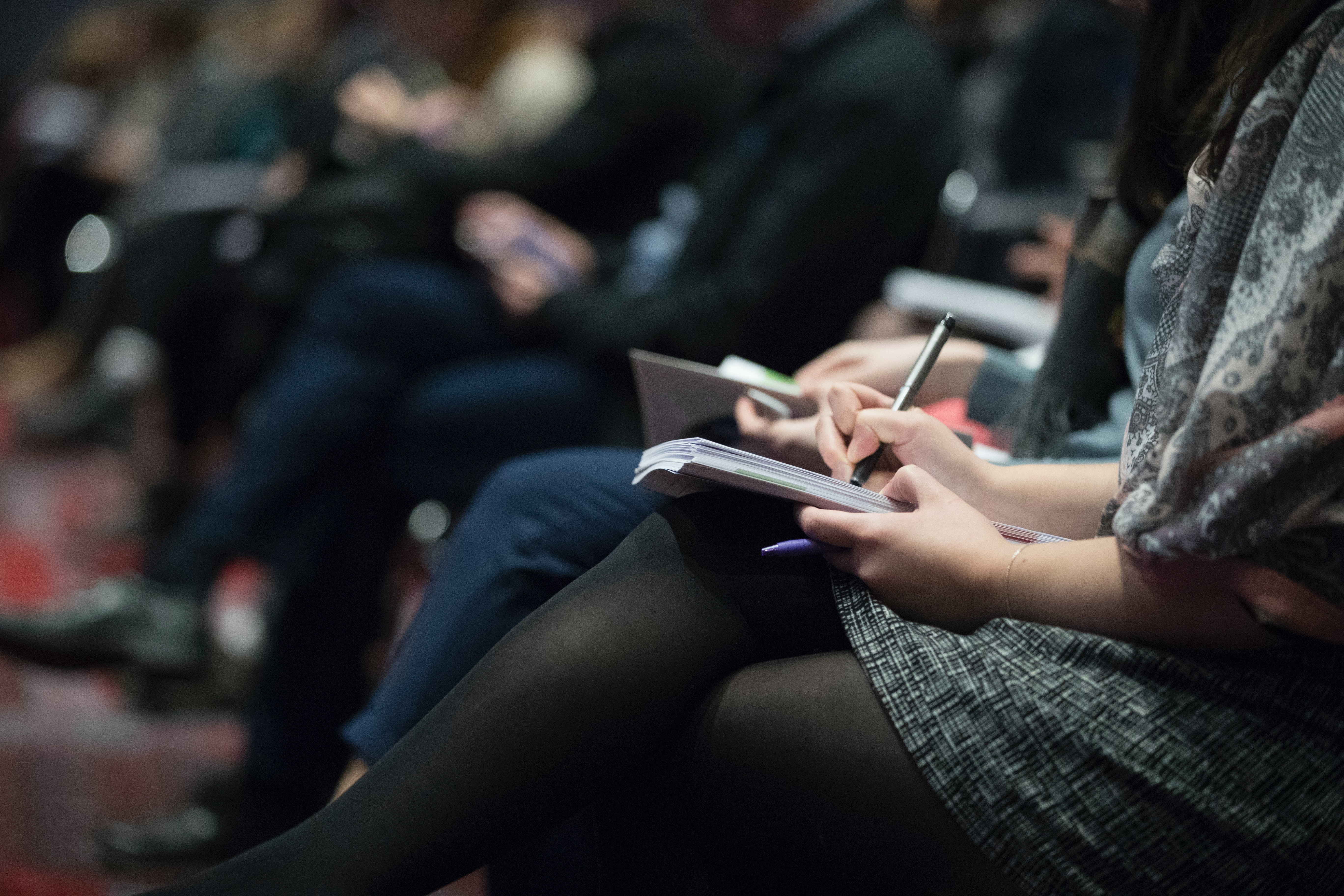 People sitting in the audience for a presentation