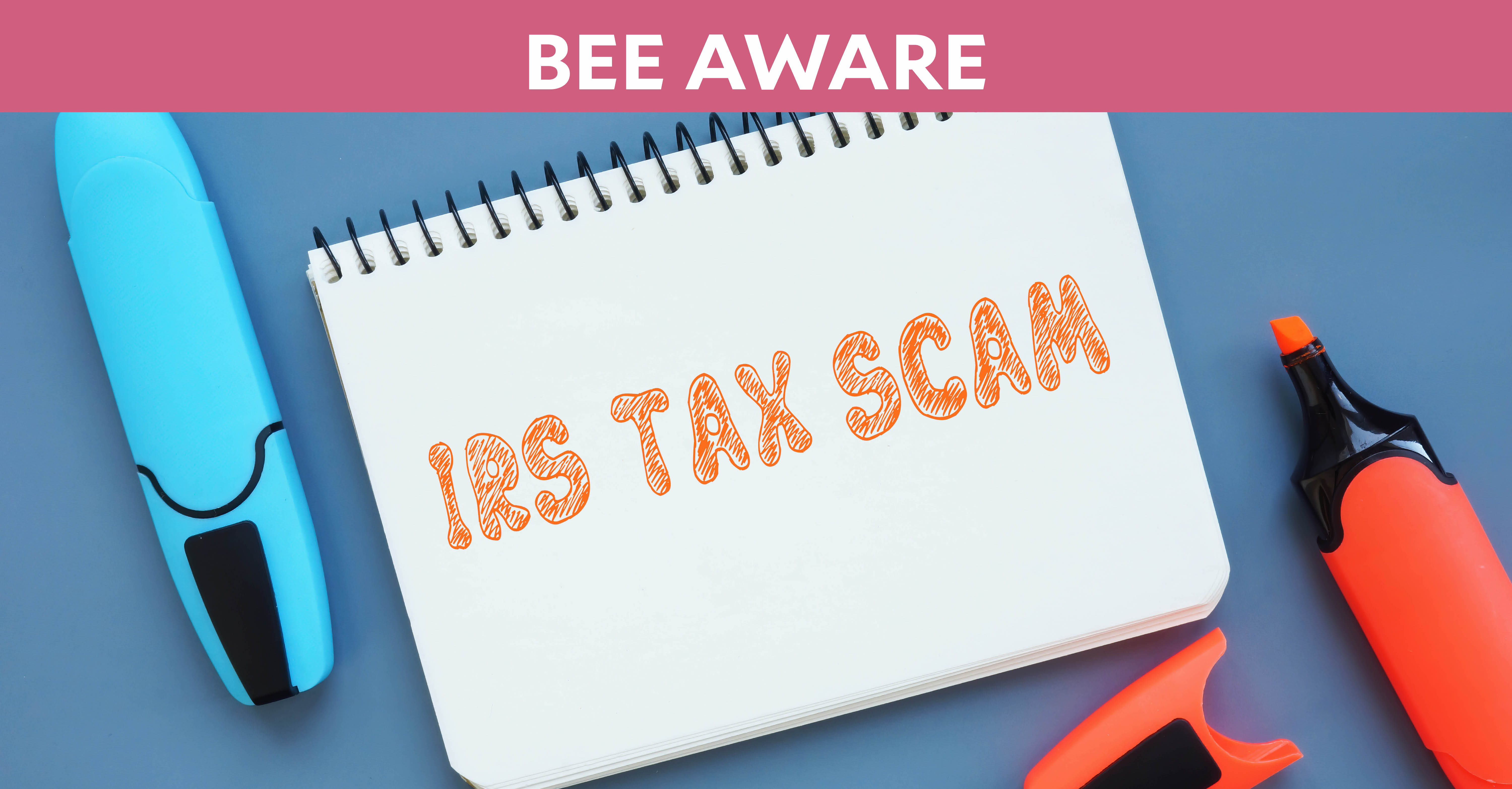 Bee Aware Hero: "IRS Tax Scam" written on notepad