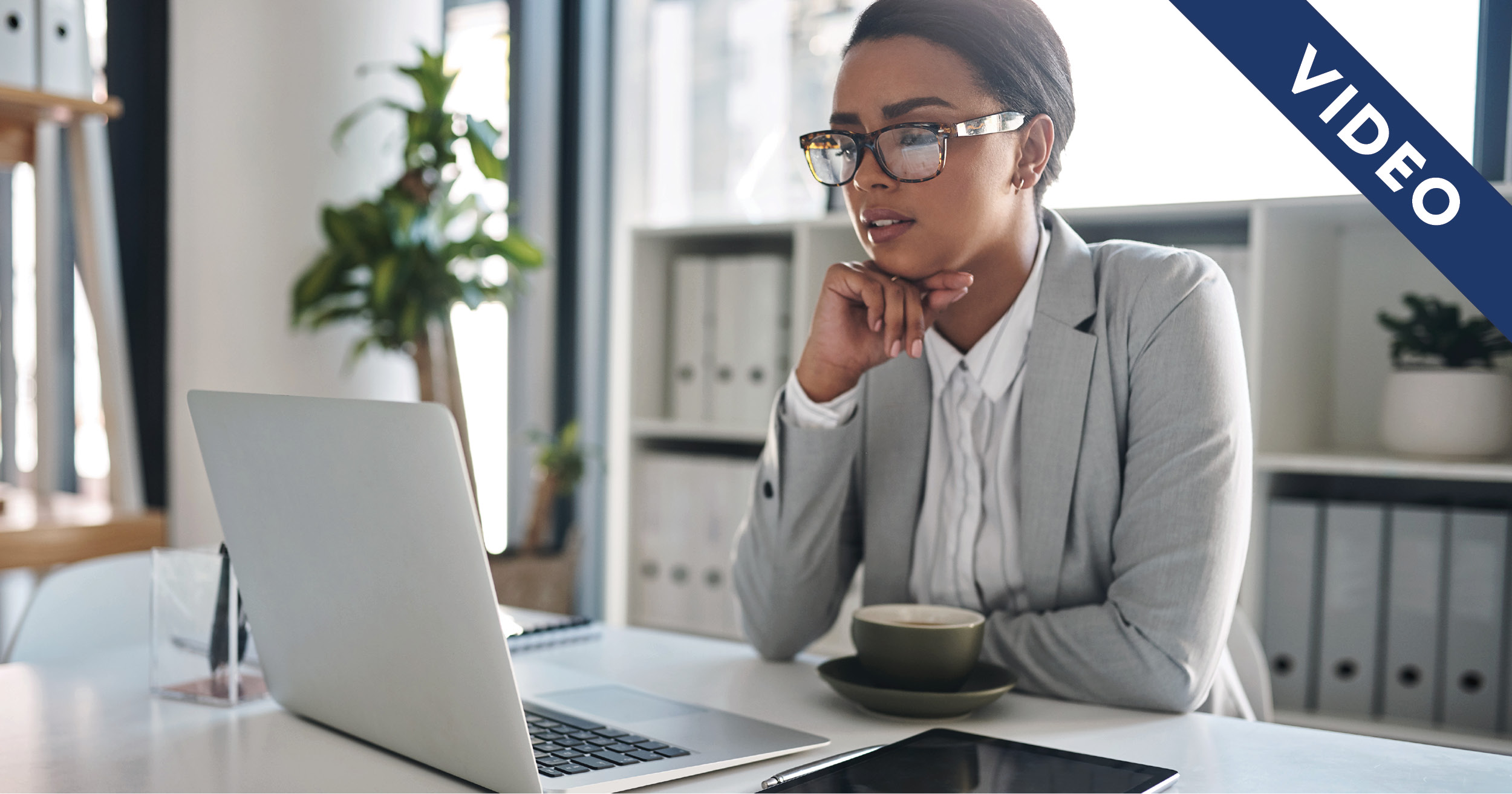Woman looking at laptop thoughtfully