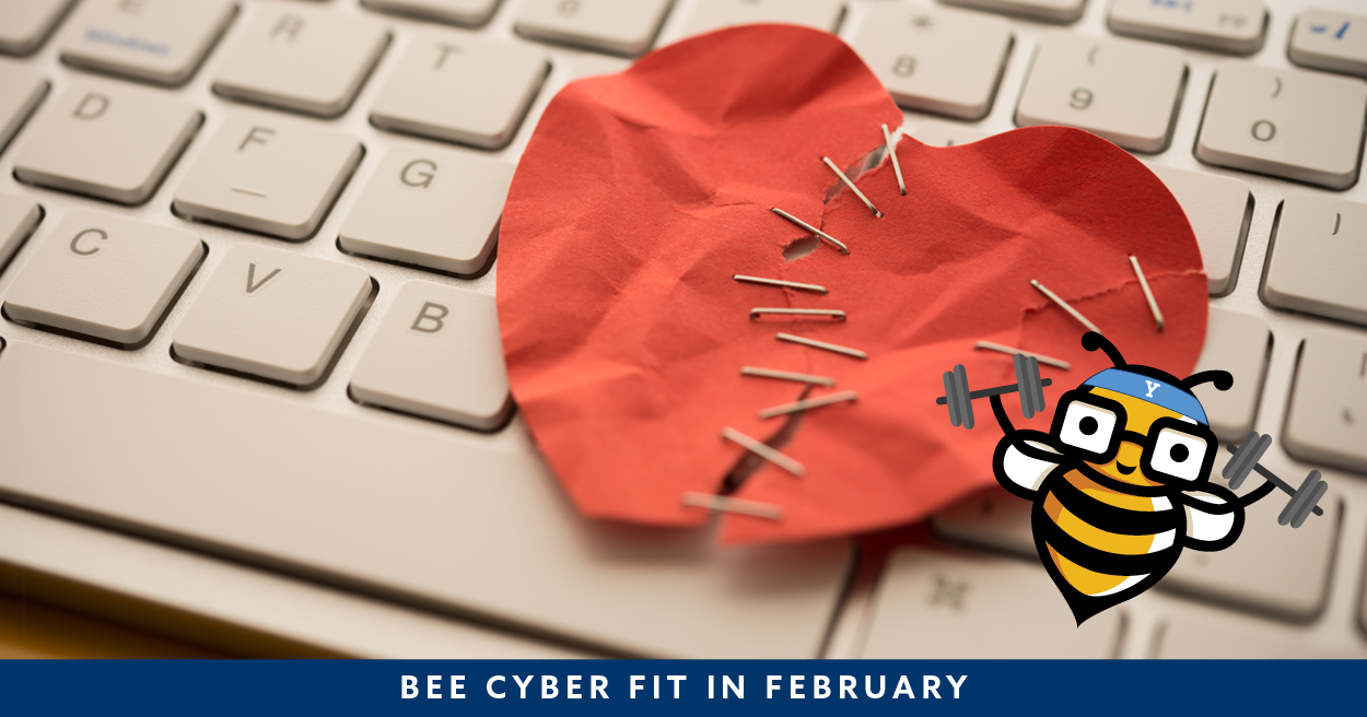 Torn paper heart with staples on keyboard with Bee Cyber Fit bee logo