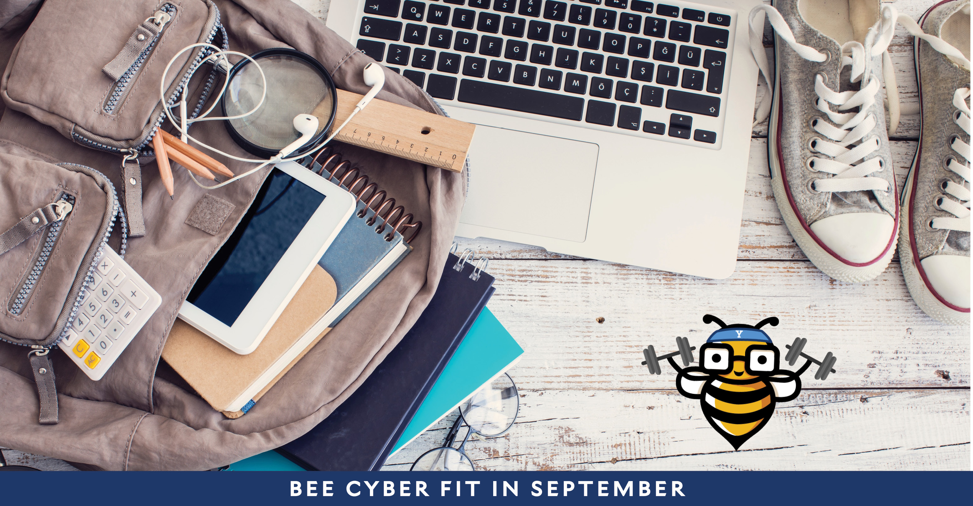 Laptop next to backpack of school supplies with the Bee Cyber Fit bee logo