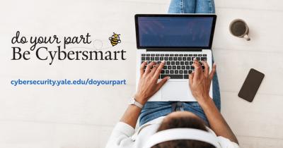 Person listening to headphones and typing on laptop