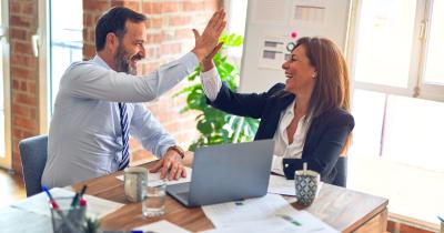 Man and woman high fiveing