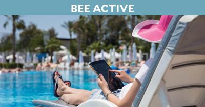 Woman in lounge chair at pool with tablet