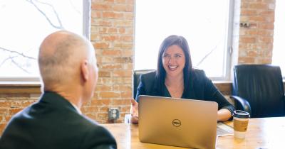 Business associated laughing at a conference table