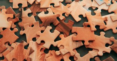 Scattered woodgrain puzzle pieces
