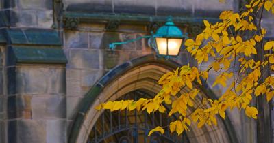 Yale archway with lamp and tree limb with fall-colored leaves