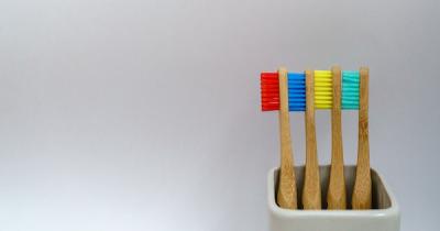 Four toothbrushes in a cup