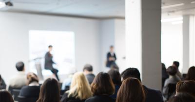 Two speakers in front of audience