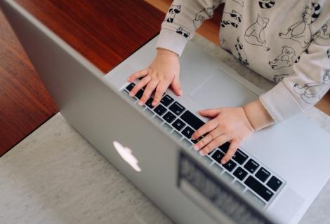 This shows a kid using a Yale laptop. Limit secondary use of your Yale devices while working from home.