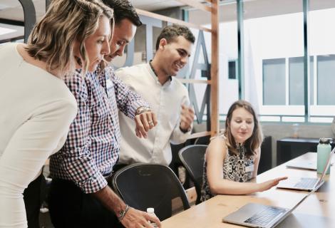 This shows staff members looking at a computer.