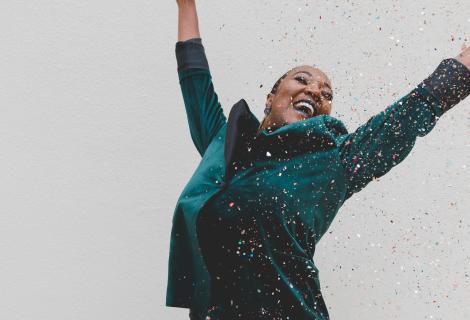 Excited woman with arms raised