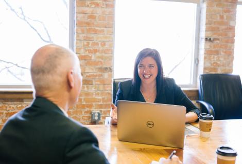Business associated laughing at a conference table