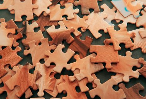 Scattered woodgrain puzzle pieces