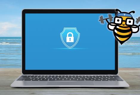 Laptop at the beach with Bee Cyber Fit bee logo